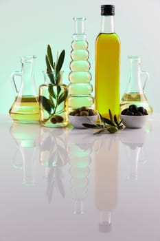 Bottles of olive oil, olive branch and Cooking oils