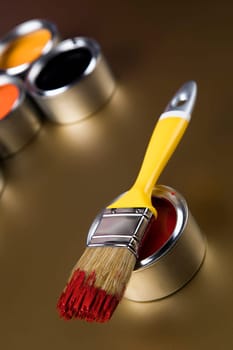 Tin metal cans with color paint and paintbrush