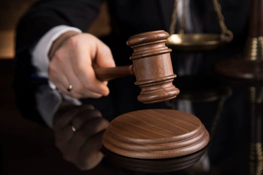 Judge, male judge in a courtroom striking the gavel