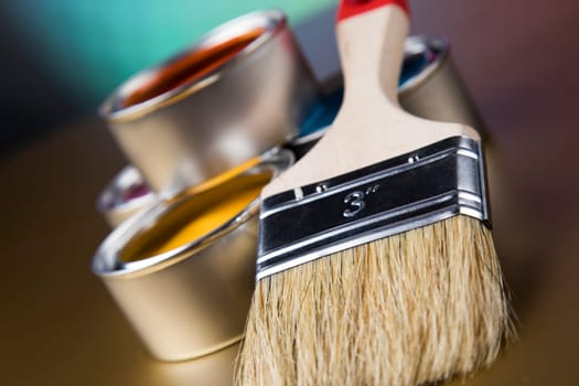 Tin metal cans with color paint and paintbrush