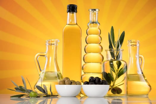 Bottles with organic cooking olive oil and olive branch