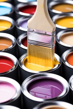 Metal tin cans with color paint and paintbrush