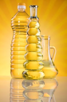 Olive oil, rapeseed oil, sunflower oil on sunburst orange background
