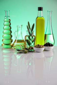 Bottles of olive oil, olive branch and Cooking oils