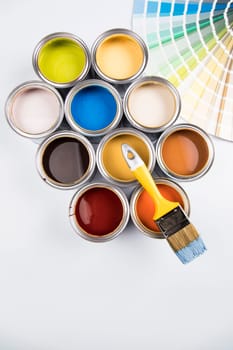 Metal tin cans with color paint and paintbrush