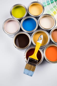 Tin metal cans with color paint and paintbrush