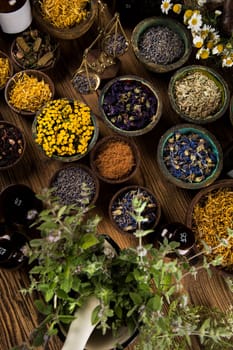 Homeopathy, herbal medicine on wooden table