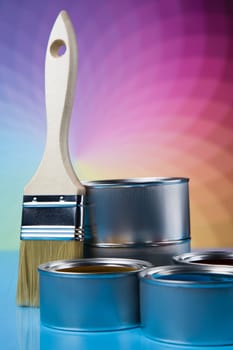 Metal tin cans with color paint and paintbrush