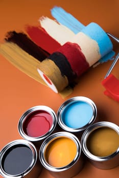Tin metal cans with color paint and paintbrush