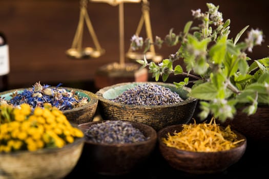 Alternative health, fresh herbal and mortar in black mirror background