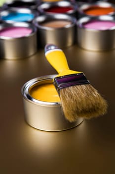 Metal tin cans with color paint and paintbrush