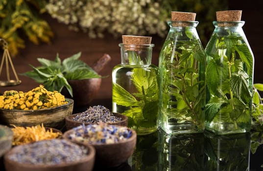Oil and Natural medicine, wooden table background