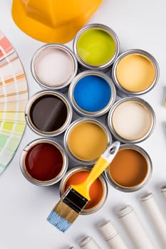 Metal tin cans with color paint and paintbrush