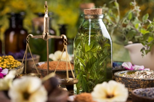 Homeopathy, herbal medicine on wooden table
