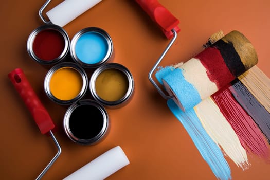 Tin metal cans with color paint and paintbrush