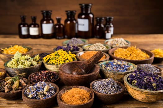 Homeopathy, herbal medicine on wooden table