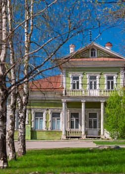 Green old wood log house in Vologda Russia. Traditional architecture and travel on sunny day