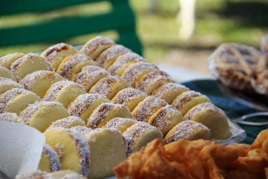 alfajores fried cakes and churros for sale at the street fair
