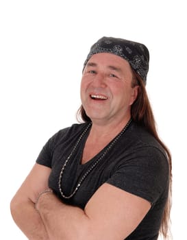 A happy indigenous man standing for a portrait image laughing, .his long brunette hair, isolated for white background.
