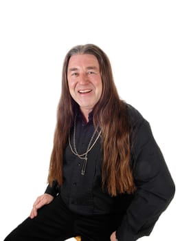 A middle age indigenous man in a portrait picture wearing a black.shirt and jewellery with his long hair, isolated for white background.