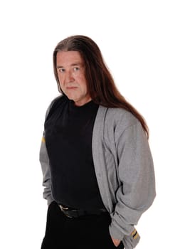 A serious looking indigenous man standing for a portrait image .his long brunette hair, isolated for white background.