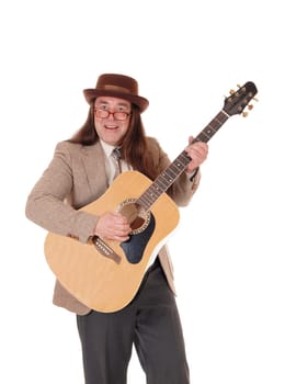 A handsome indigenous man in a jeans jacket, pants and a cowboy hat.standing and playing the guitar, isolated for white background.