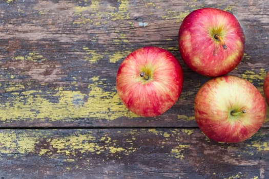 red apples background on rustic wood