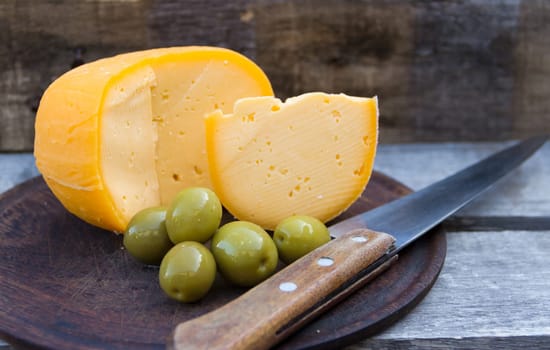 field cheese olives and tomatoes on rustic wood