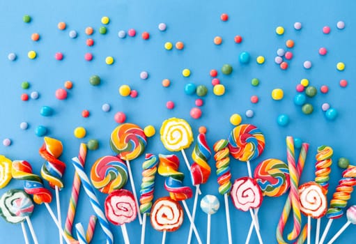 Colorful sweets and lollipops on a blue background