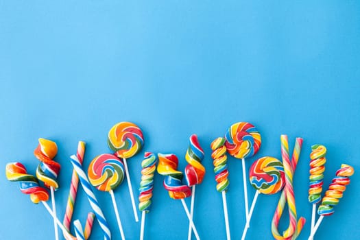 Colorful sweets and lollipops on a blue background