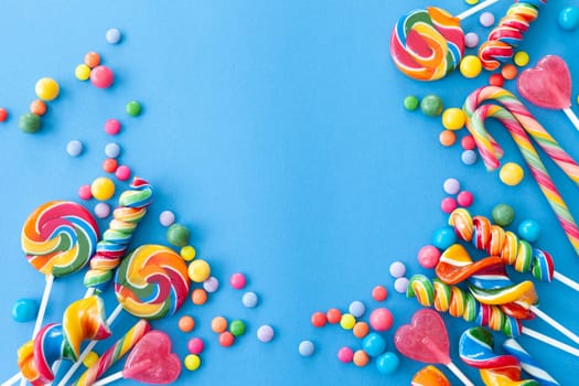 Colorful sweets and lollipops on a blue background