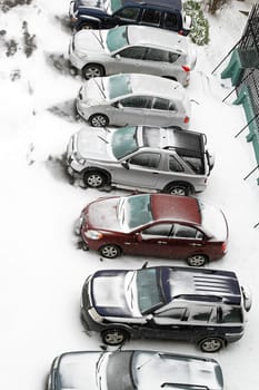 Vehicles and parking under the snow in winter