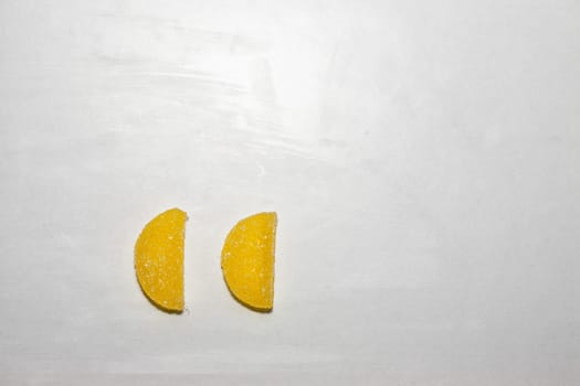 Two Sugar candies shaped as half moon.