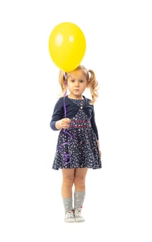 portrait of isolated blonde little girl holding yellow ballon