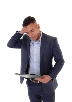 A young man is looking at his clipboard and is very disappointed .about what he sees , isolated for white background.