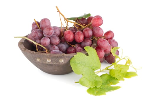 Fresh red grapes in wood bown isolated on white background.