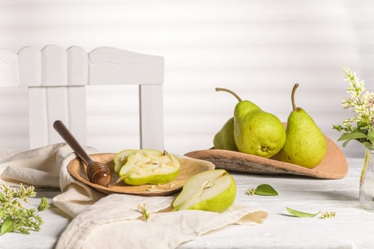 Tasty pears with honey and nuts on wooden table.