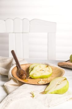 Tasty pears with honey and nuts on wooden table.