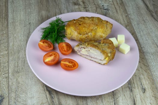 Pieces of cutted thin Armenian pita bread or lavash wrapped tomatoes, cottage cheese or curd, chicken meat, tomatoes and herbs - dill, onion, parsley with vintage knife on cutting board.
