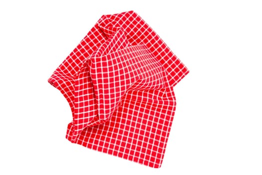 Closeup of a red and white checkered napkin or tablecloth texture isolated on white background. Kitchen accessories.
