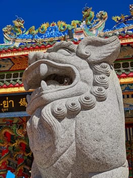 Chinese Lion Figurine, stone sculpture in front of Chinese temple