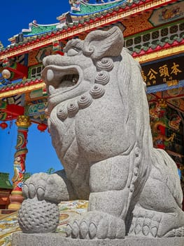Chinese Lion Figurine, stone sculpture in front of Chinese temple