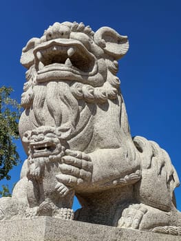 Chinese Lion Figurine, stone sculpture in front of Chinese temple