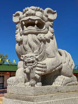Chinese Lion Figurine, stone sculpture in front of Chinese temple