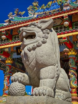 Chinese Lion Figurine, stone sculpture in front of Chinese temple