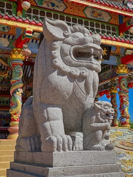 Chinese Lion Figurine, stone sculpture in front of Chinese temple