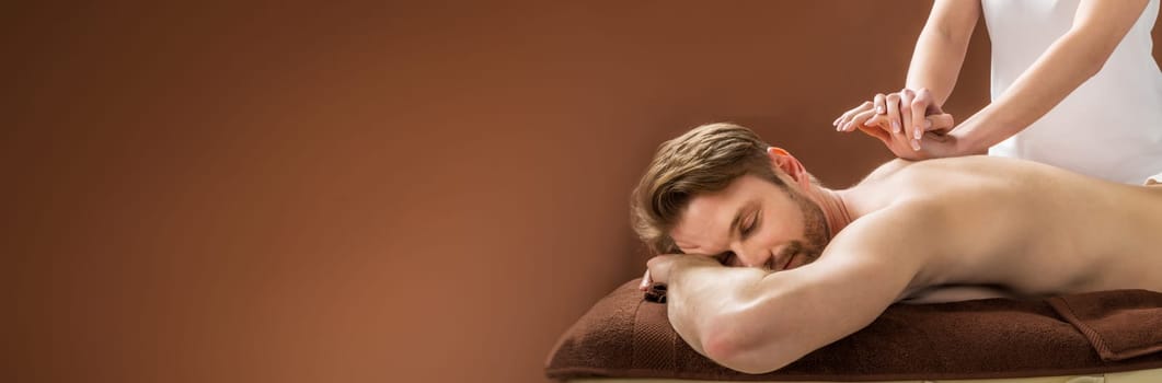 Portrait Of A Young Man Receiving Back Massage At A Beauty Spa