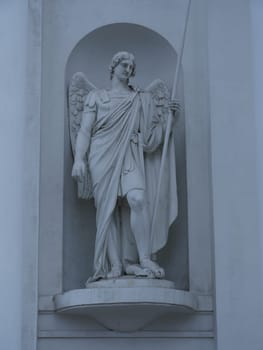 Statue of Archangel Michael with a spear striking a snake