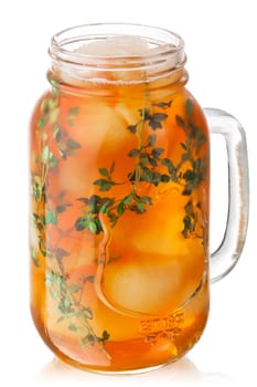 Iced thyme tea in a mason jar, isolated