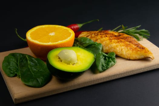 Ketogenic diet concept. A set of products of the low carb keto diet. Green vegetables, nuts, chicken fillet, flax seeds, quail eggs, cherry tomatoes. Healthy food concept. Keto diet food.